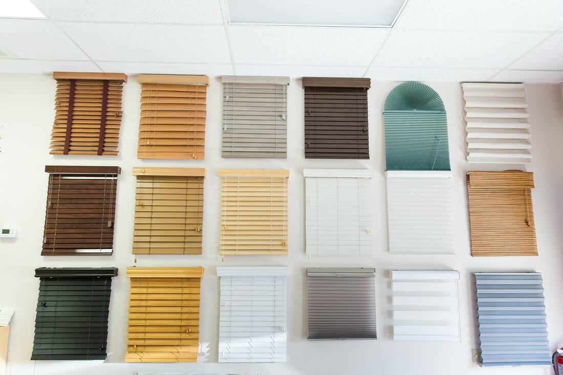 Picture of a wall of sample window coverings in the showroom of Custom Discount Blinds